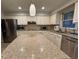 Modern kitchen with granite countertop island, white cabinets, and stainless steel refrigerator at 990 Azalea Dr, Roswell, GA 30075