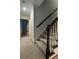 Carpeted staircase with dark wood handrail and trim leading to an open landing at 990 Azalea Dr, Roswell, GA 30075