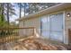 Exterior angle of wooden back deck showing railings, stairs, and sliding glass doors to home interior at 6307 Thornhedge Dr, Riverdale, GA 30296