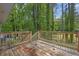 Wooden back deck overlooking a beautiful wooded backyard with mature trees and natural landscaping at 6307 Thornhedge Dr, Riverdale, GA 30296