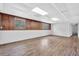 Spacious basement area featuring gray vinyl floors, white block walls, and natural light from two windows at 6307 Thornhedge Dr, Riverdale, GA 30296