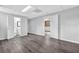 Spacious basement with gray wood floors, neutral paint, and a glimpse into the bathroom and windowed room at 6307 Thornhedge Dr, Riverdale, GA 30296