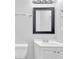The bathroom boasts a corner sink with vanity and a dark framed mirror at 6307 Thornhedge Dr, Riverdale, GA 30296