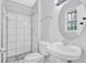 Bathroom features walk-in shower with decorative tile and stylish vanity at 6307 Thornhedge Dr, Riverdale, GA 30296