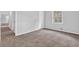 A carpeted bedroom featuring a window and neutral walls, offering a calm and inviting space at 6307 Thornhedge Dr, Riverdale, GA 30296