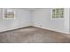 Bedroom featuring carpet and two windows providing lots of natural light at 6307 Thornhedge Dr, Riverdale, GA 30296