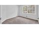 Bedroom with neutral carpet, window and light grey walls at 6307 Thornhedge Dr, Riverdale, GA 30296