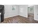 Dining area showcasing modern laminate flooring, natural light, and neutral paint at 6307 Thornhedge Dr, Riverdale, GA 30296
