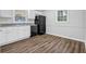 Dining area showcasing modern laminate flooring, natural light, and neutral paint at 6307 Thornhedge Dr, Riverdale, GA 30296