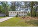Charming two-story home featuring a classic brick facade, attached garage, and a well-maintained front yard at 6307 Thornhedge Dr, Riverdale, GA 30296