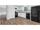 Bright kitchen with white cabinets, black appliances, modern countertops and flooring at 6307 Thornhedge Dr, Riverdale, GA 30296