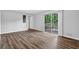 Spacious living room with hardwood floors and sliding glass doors to outdoor deck at 6307 Thornhedge Dr, Riverdale, GA 30296