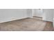 Bright living room featuring neutral paint, cozy carpet, and large windows offering ample natural light at 6307 Thornhedge Dr, Riverdale, GA 30296