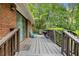 Back deck featuring wood floors, a welcome mat, and views of nature at 801 Sugar Creek Se Trl, Conyers, GA 30094
