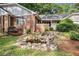 A charming backyard featuring a decorative pond, lush greenery, and a swing at 801 Sugar Creek Se Trl, Conyers, GA 30094