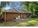 Backyard featuring a deck, brick siding, and mature trees at 801 Sugar Creek Se Trl, Conyers, GA 30094