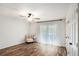 Light and bright bedroom with wood floors, neutral walls, closet, and ceiling fan at 801 Sugar Creek Se Trl, Conyers, GA 30094