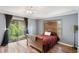 Cozy bedroom featuring hard wood floors, sliding glass door, and nice lighting at 801 Sugar Creek Se Trl, Conyers, GA 30094