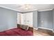 Comfortable bedroom with wood-look floors, large closets, and neutral paint at 801 Sugar Creek Se Trl, Conyers, GA 30094