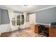 Spacious home office with large windows, hardwood floors, and a classic wooden desk at 801 Sugar Creek Se Trl, Conyers, GA 30094