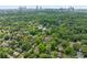 A high-angle aerial view of a quiet neighborhood, showing tree-lined streets and houses with greenery at 1028 Amsterdam Ne Ave, Atlanta, GA 30306