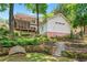 Spacious backyard featuring a terraced garden, trampoline, and steps leading to the main house at 1028 Amsterdam Ne Ave, Atlanta, GA 30306