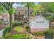 Landscaped backyard featuring a lush lawn, stone steps, a detached garage, and multi-level patios at 1028 Amsterdam Ne Ave, Atlanta, GA 30306