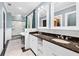 Elegant bathroom with a double sink vanity, marble floors, and a glass-enclosed shower and soaking tub for a spa-like experience at 1028 Amsterdam Ne Ave, Atlanta, GA 30306
