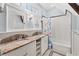 Bright bathroom featuring double sinks with granite countertops, tub and a tiled shower at 1028 Amsterdam Ne Ave, Atlanta, GA 30306