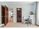 Functional bedroom with a desk, neutral carpet, and convenient access to laundry for efficient living at 1028 Amsterdam Ne Ave, Atlanta, GA 30306