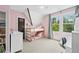 Pink bedroom with a bunk bed and natural light from the two windows overlooking the trees at 1028 Amsterdam Ne Ave, Atlanta, GA 30306