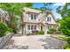 Charming home featuring a stylish brick driveway, manicured shrubs, and a two-car garage at 1028 Amsterdam Ne Ave, Atlanta, GA 30306