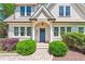 Charming front exterior of a two-story home with manicured bushes and a brick-paved walkway at 1028 Amsterdam Ne Ave, Atlanta, GA 30306