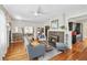 Spacious living room with a brick fireplace, hardwood floors, and an open layout to the kitchen at 1028 Amsterdam Ne Ave, Atlanta, GA 30306
