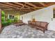 Covered outdoor patio with stone flooring and wood furnishings, perfect for relaxing or entertaining at 1028 Amsterdam Ne Ave, Atlanta, GA 30306