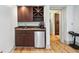 Convenient wet bar area featuring custom cabinets, a mini-fridge, and a sink, perfect for entertaining guests or enjoying a beverage at 1028 Amsterdam Ne Ave, Atlanta, GA 30306