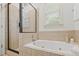Bathroom with jetted tub, shower and tiled walls at 301 Fortune Ne St, Atlanta, GA 30312