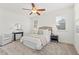 Bright bedroom featuring neutral decor, a ceiling fan, bedside tables, and natural light from multiple windows at 301 Fortune Ne St, Atlanta, GA 30312