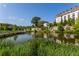 Scenic community lake view with lush landscaping, walking bridge, and upscale apartment buildings at 301 Fortune Ne St, Atlanta, GA 30312