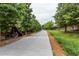 Picturesque community walkway lined with brick buildings and lush green trees along the path at 301 Fortune Ne St, Atlanta, GA 30312