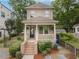 Charming two-story home featuring a welcoming front porch, landscaped yard, and well-maintained exterior at 301 Fortune Ne St, Atlanta, GA 30312