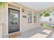 Inviting front porch with gray flooring, a black front door, and classic architectural details at 301 Fortune Ne St, Atlanta, GA 30312