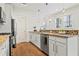Bright kitchen with granite counters, stainless appliances, white cabinets, and hardwood floors at 301 Fortune Ne St, Atlanta, GA 30312
