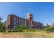 Historic Ponce building featuring brick facade, tower, vibrant signage, and mature landscaping at 301 Fortune Ne St, Atlanta, GA 30312
