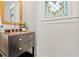 Stylish powder room showcases a marble-topped vanity and stained glass window at 301 Fortune Ne St, Atlanta, GA 30312