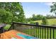 Wooden deck overlooks green yard area with mature trees in the background at 5077 Newpark Nw Dr, Acworth, GA 30101
