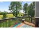 View from a wooden deck with a railing overlooking a spacious green yard with mature trees at 5077 Newpark Nw Dr, Acworth, GA 30101