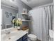 Bathroom with a shower-tub combo, blue vanity and a large mirror at 5077 Newpark Nw Dr, Acworth, GA 30101
