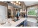 Bright bathroom featuring a double vanity with a large mirror and natural light at 5077 Newpark Nw Dr, Acworth, GA 30101