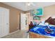 Comfortable bedroom with a ceiling fan, bright walls, and a closet door at 5077 Newpark Nw Dr, Acworth, GA 30101